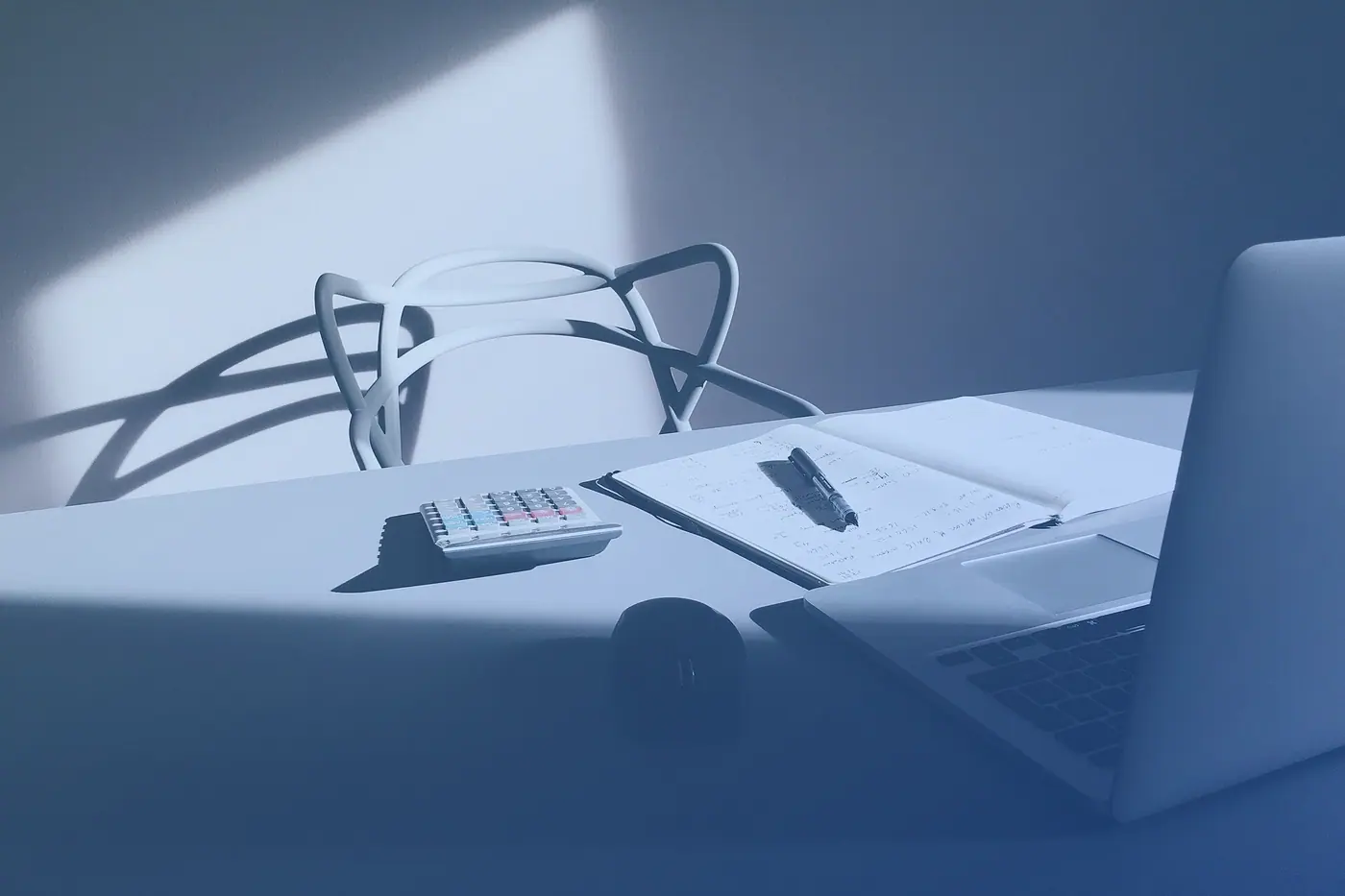 A laptop and calculator on a desk